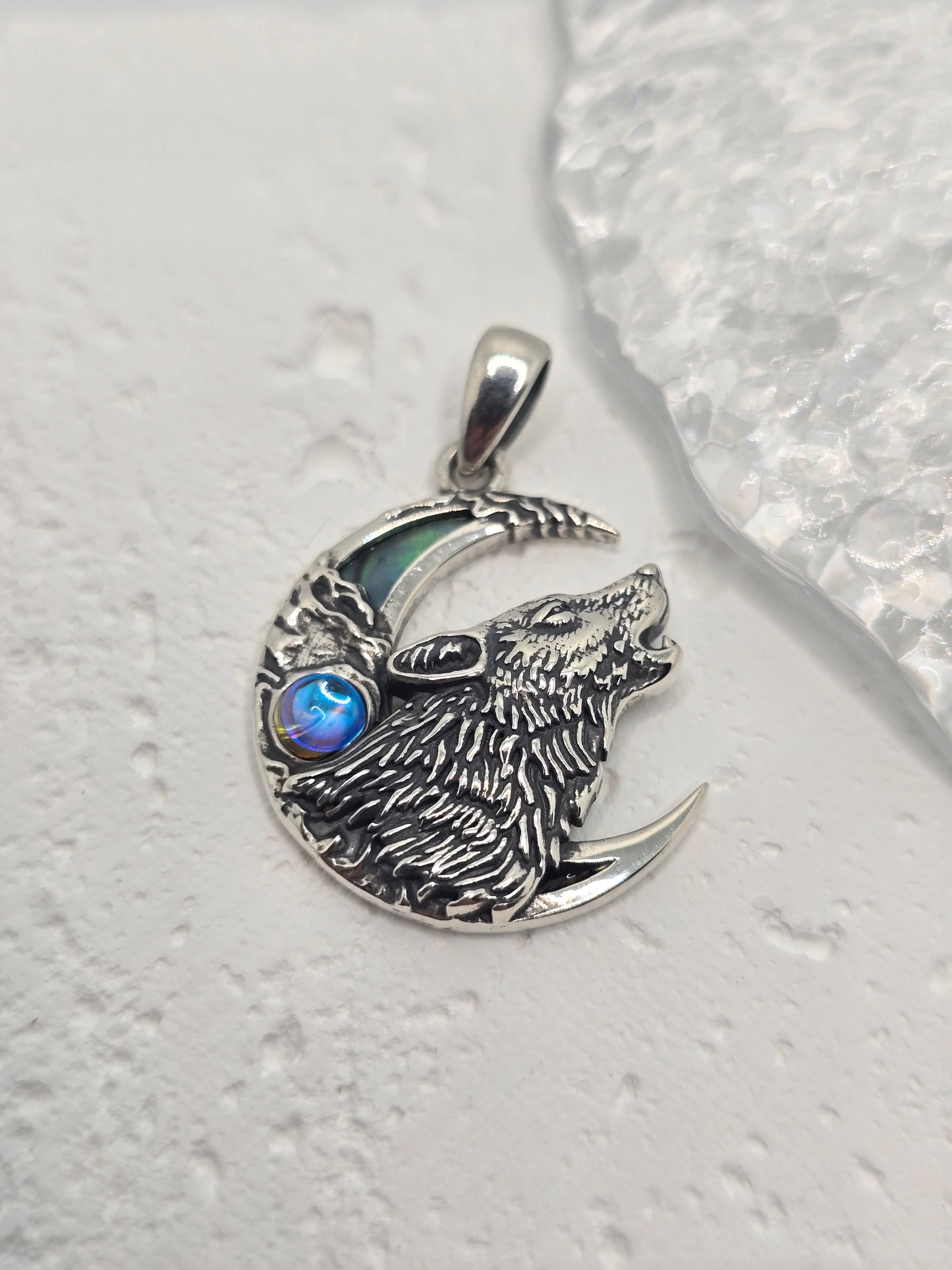 Call on lunar magic and wild intuition with the Wolf & Moon Pendant, crafted in luminous 925 sterling silver and set with an iridescent abalone shell crescent. A finely detailed wolf howls against the night-sky backdrop, celebrating guidance, freedom, and the quiet power of the wild.
Wear it as a symbol of inner strength or gift it to someone who feels at home under moonlight—this piece blends meaningful symbolism with elegant, everyday style.
Key Features:
Made from high-quality 925 Sterling Silver