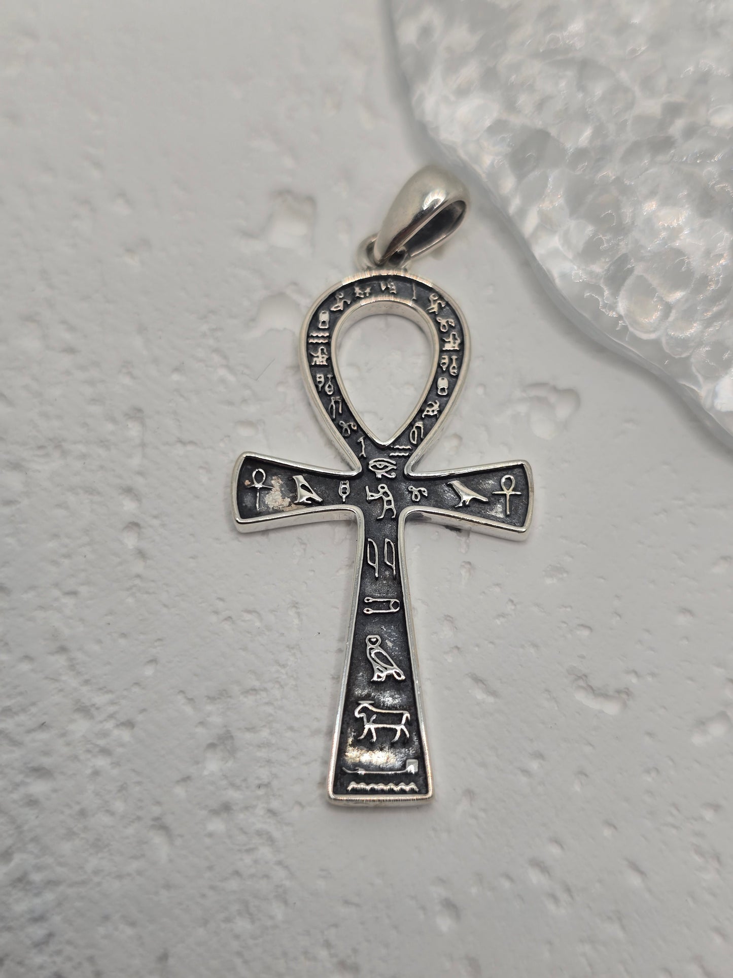 Embrace the mystique of ancient Egypt with the Ankh Cross Pendant, crafted in luminous 925 sterling silver. Known as the key of life, the Ankh symbolises eternal life, divine power, and renewal—bridging the earthly world with the afterlife.
Historically inspired detailing and Egyptian hieroglyphs add cultural depth and authenticity. Polished silverwork highlights the graceful loop and crossbar, creating a meaningful talisman and a striking everyday accessory for lovers of history, mythology, and symbolic j