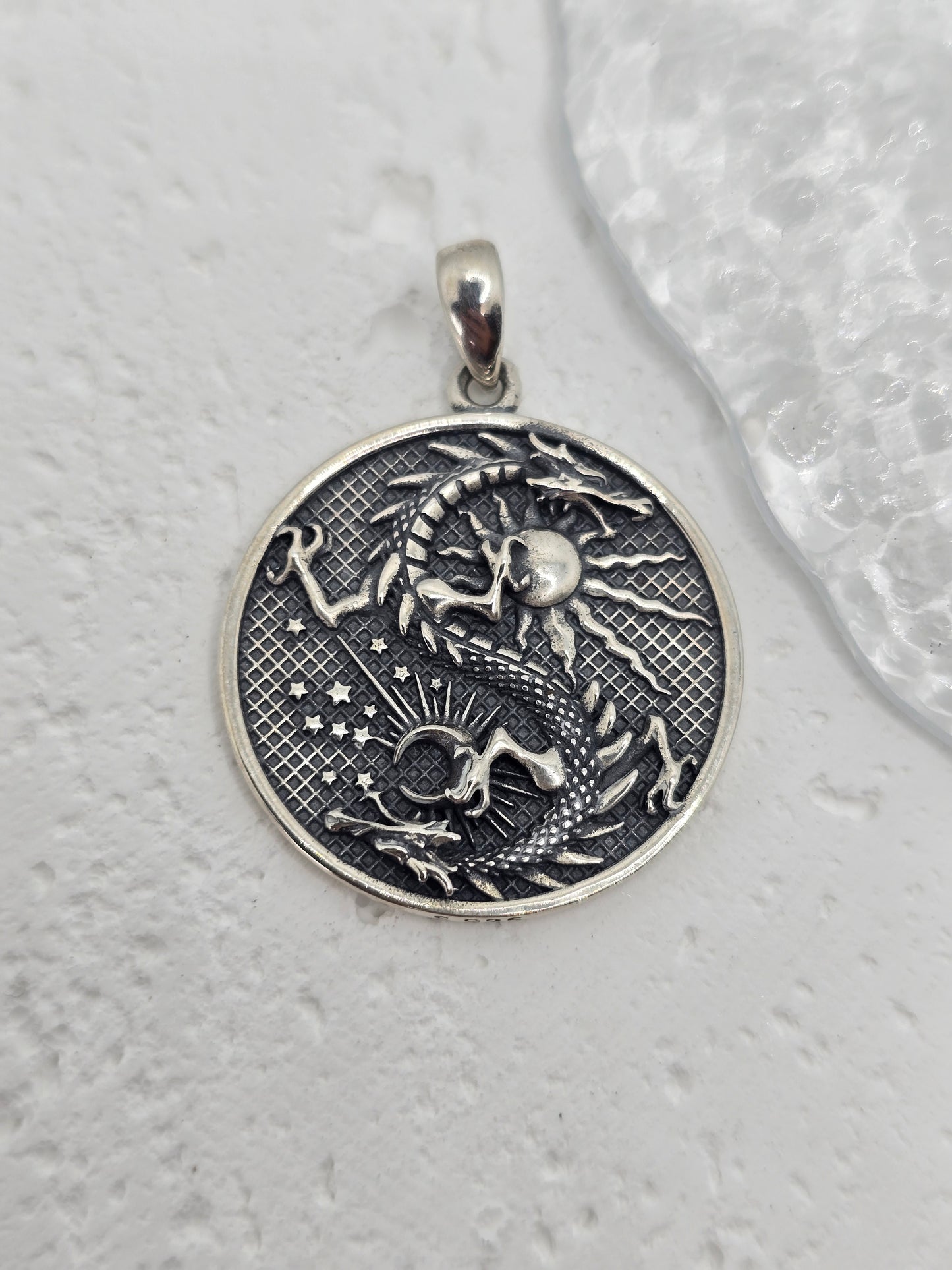 Unleash celestial power with this bold and mystical Moon Dragon Necklace, expertly crafted in 925 sterling silver. This captivating pendant brings together the sun and moon—symbols of duality and cosmic balance—with a majestic dragon, a timeless emblem of strength, transformation, and personal power.
The dragon coils through the sun and moon in an eternal dance, representing the unity of opposites: light and dark, masculine and feminine, action and reflection. The intricate textures and engravings bring th