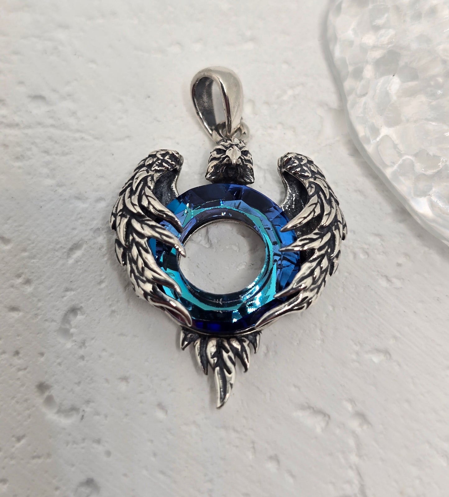 Channel strength, freedom, and clarity with the Eagle Wings Amulet, crafted in luminous 925 sterling silver and set with a deep blue Austrian crystal. Finely sculpted wings frame the radiant centre stone, creating a bold talisman that elevates everyday style and meaningful gifting.
Key Features:
Made from solid 925 Sterling Silver
Eagle wing motif symbolising power, freedom, and vision
Blue Austrian crystal centre for vibrant sparkle and depth
Polished detailing with light-catching feather texture
Ideal s
