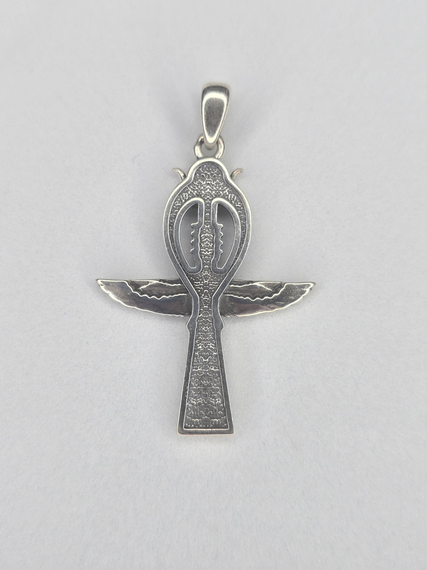 Back view of sterling silver Ankh cross amulet with textured finish and wing design