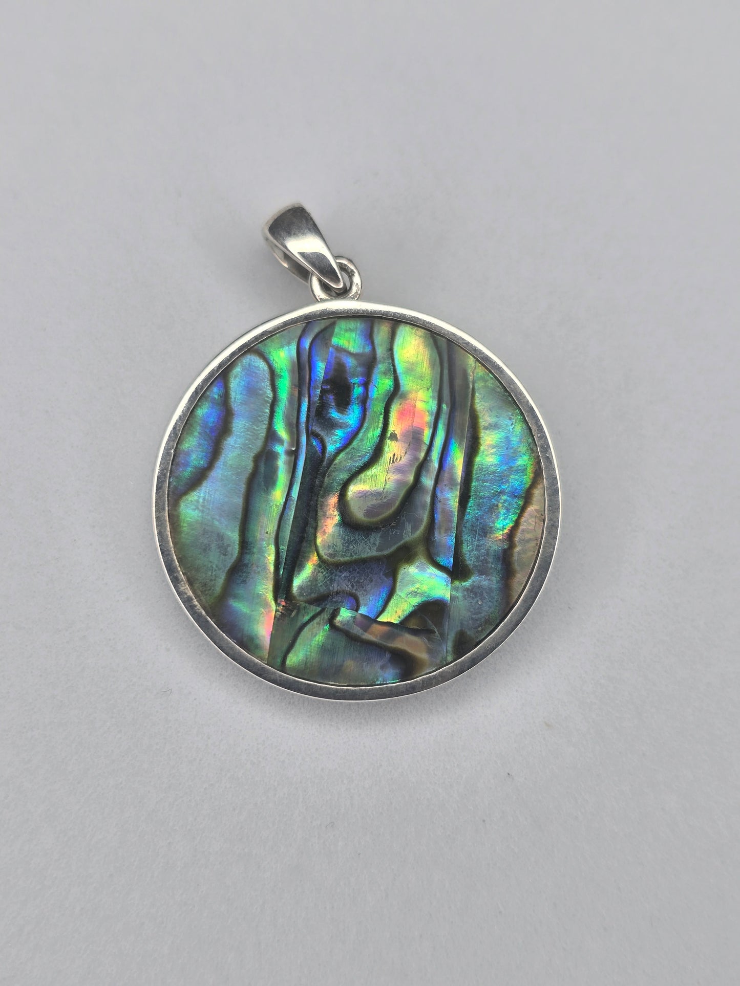 Back view of Triple Moon Goddess pendant showing natural abalone shell pattern