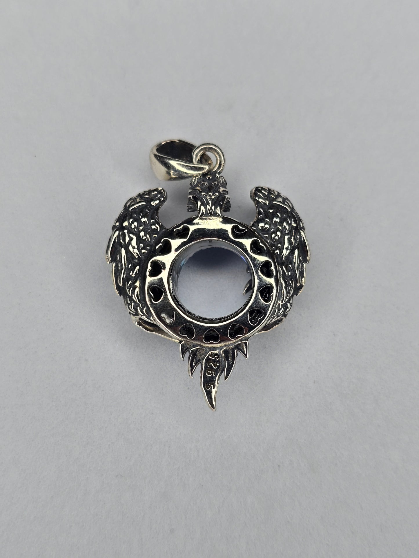 Back view of silver eagle wings pendant with open crystal setting