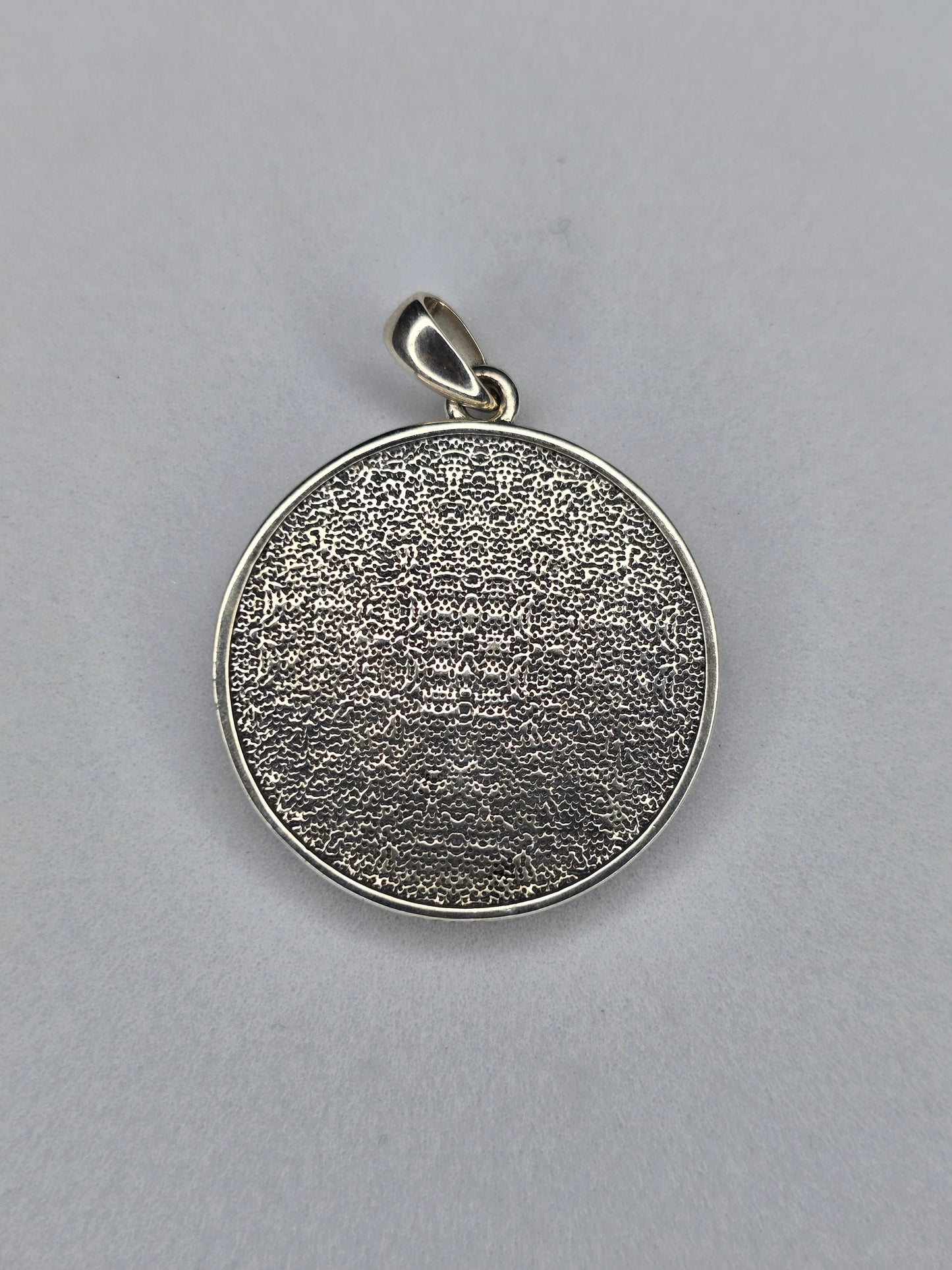 Back view of Anubis amulet with textured sterling silver surface