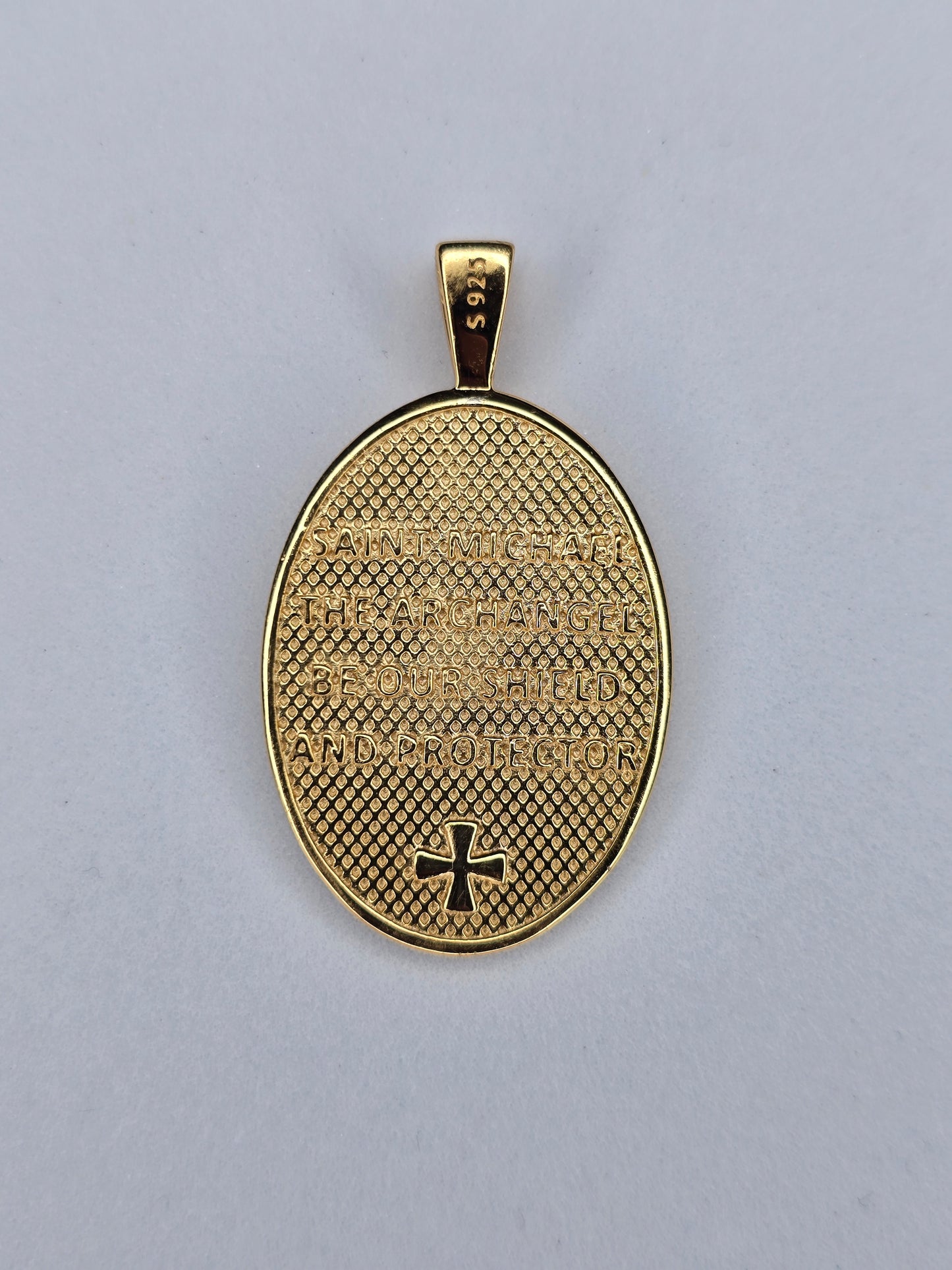 Back view of Saint Michael medal with shield and protector prayer engraving
