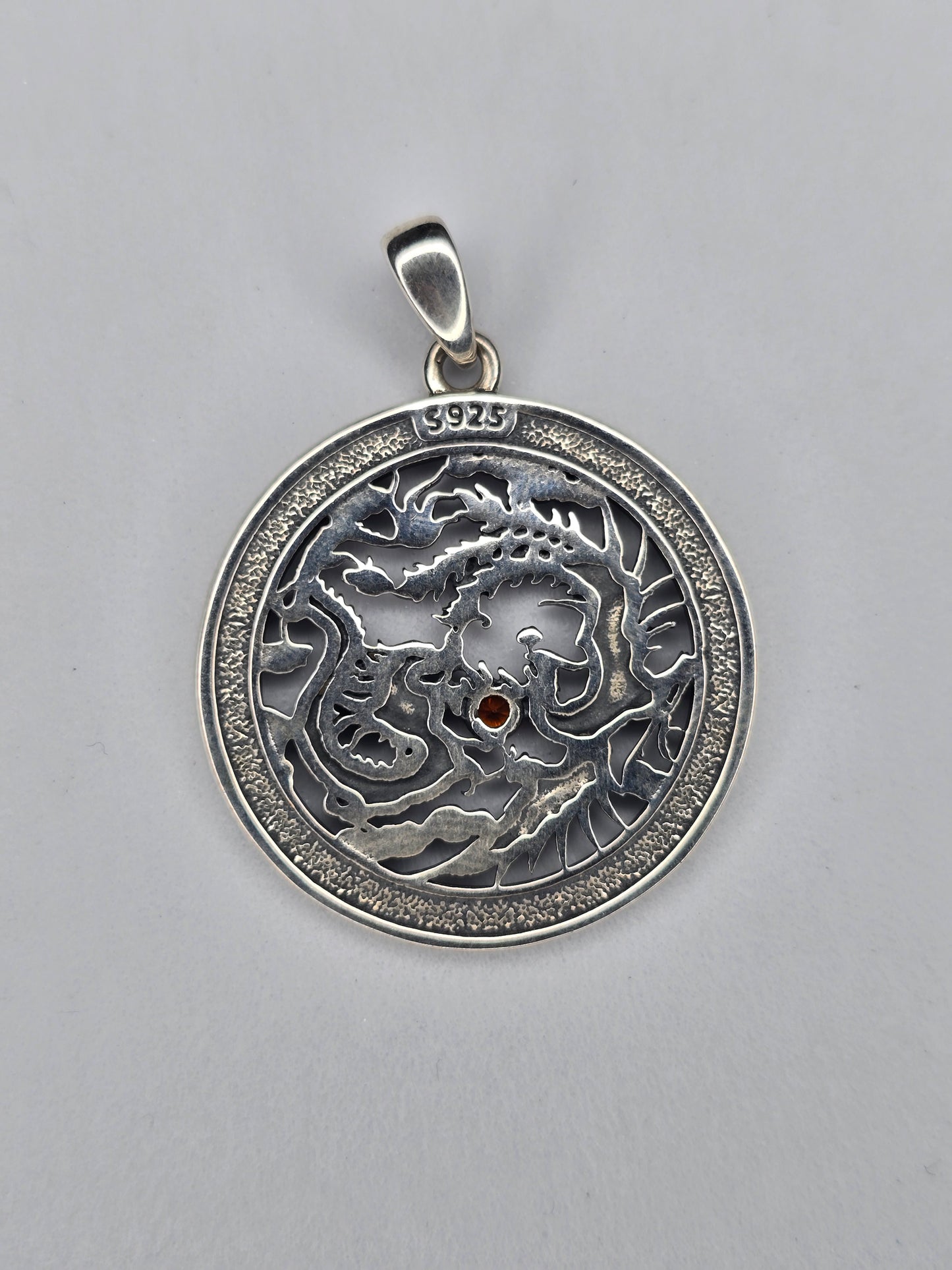 Back view of phoenix dragon sterling silver pendant with textured finish