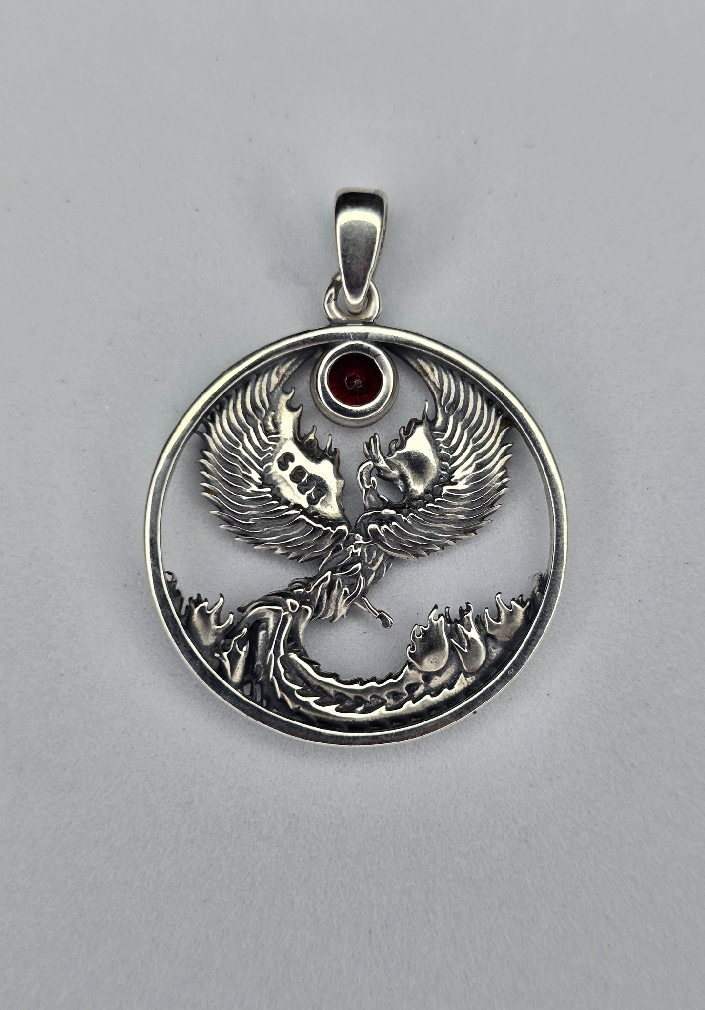Back view of sterling silver phoenix pendant with open circular design