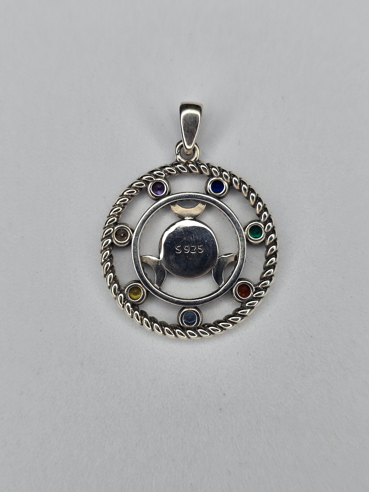 Back view of Hecate wheel pendant showing 925 sterling silver hallmark and circular triple moon design