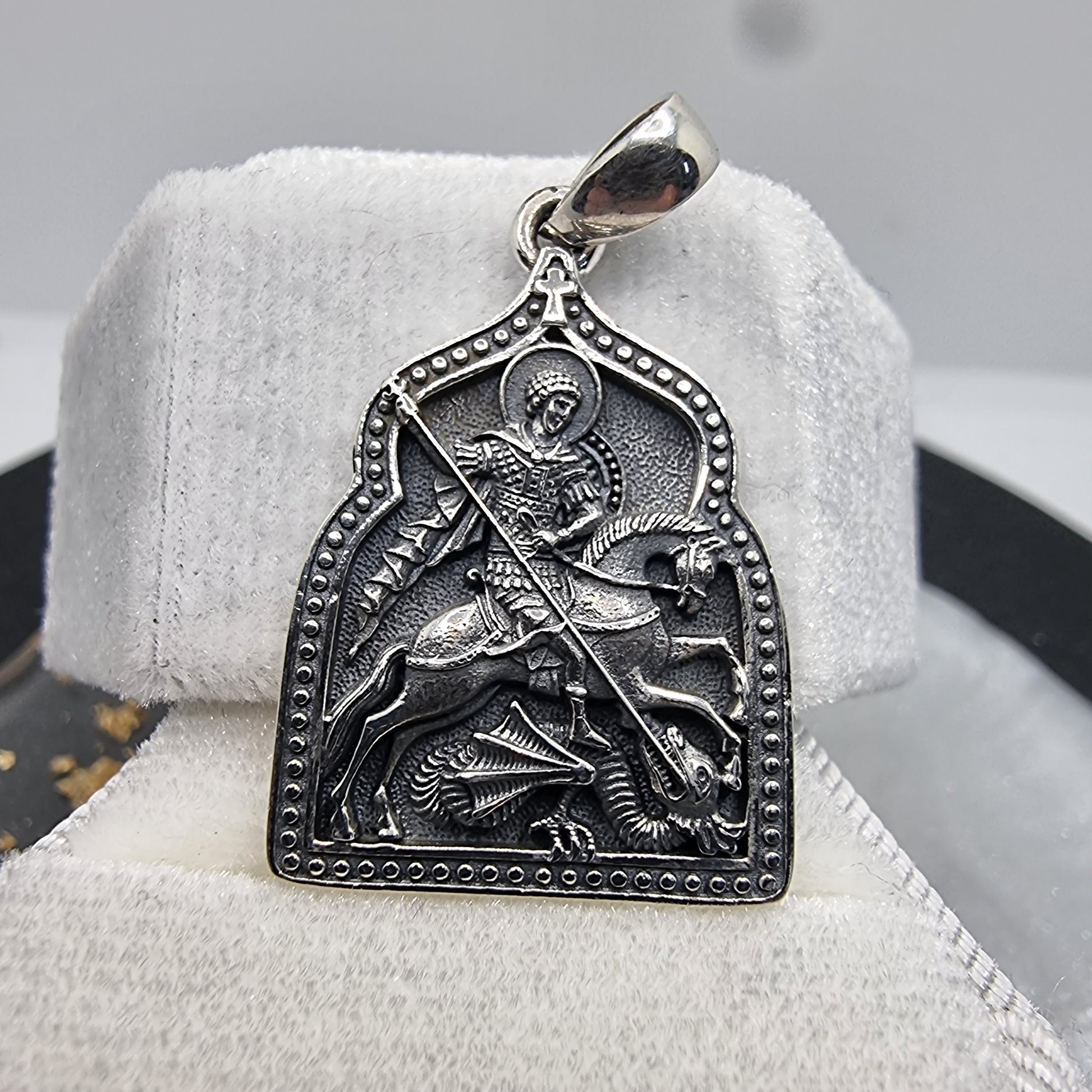 Introducing the Saint George Slaying the Dragon Pendant, a beautifully detailed piece that captures the essence of courage and faith. Crafted from high-quality 925 Sterling Silver, this pendant portrays the powerful image of Saint George in victorious battle against the dragon, a symbol of triumph over adversity.

This pendant is not only a work of art but also a meaningful symbol of protection and strength. The intricate design, combined with the sterling silver's durability, makes it a perfect accessory f