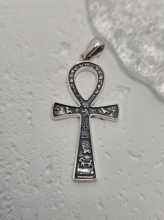 Embrace the mystique of ancient Egypt with the Ankh Cross Pendant, crafted in luminous 925 sterling silver. Known as the key of life, the Ankh symbolises eternal life, divine power, and renewal—bridging the earthly world with the afterlife.

Historically inspired detailing and Egyptian hieroglyphs add cultural depth and authenticity. Polished silverwork highlights the graceful loop and crossbar, creating a meaningful talisman and a striking everyday accessory for lovers of history, mythology, and symbolic j