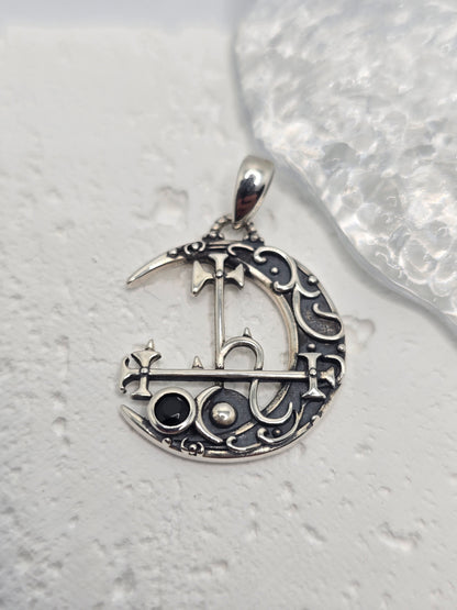 Invoke independence, intuition, and lunar mystery with the Lilith Moon Sigil Pendant, crafted in solid 925 sterling silver. A crescent moon frames Lilith’s sigil in elegant openwork, while a black gemstone at the centre adds bold contrast and dark, celestial allure. Light plays through the cutout detailing, giving the piece an ethereal, night-sky presence.

Wear it as a personal emblem of empowerment or gift it to someone who loves moon magic, folklore, and symbolic jewellery—this pendant is equal parts sta