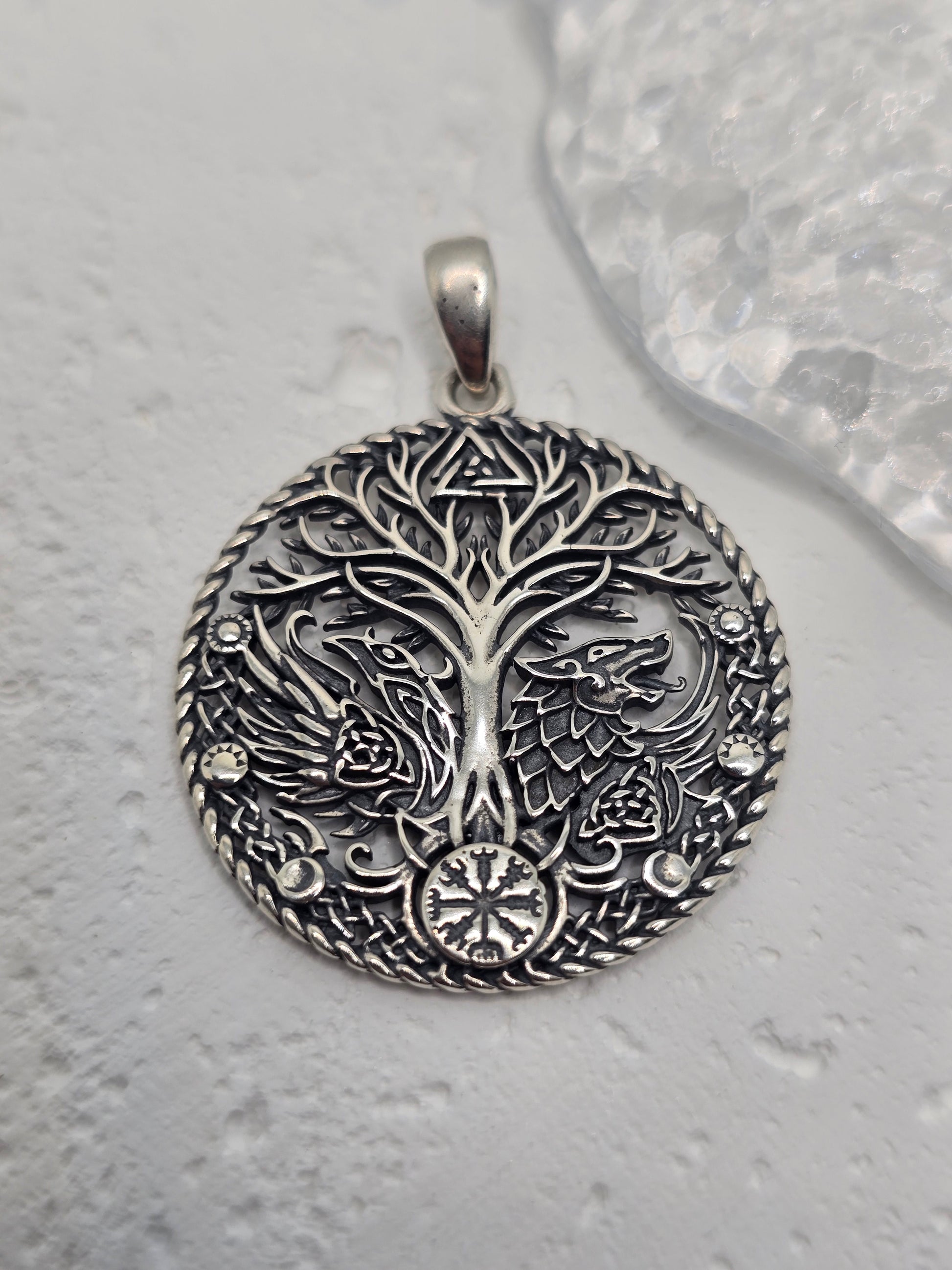 Honor ancient lore and powerful symbols with the Viking Raven Wolf Yggdrasil Pendant, crafted in solid 925 sterling silver. Centered on Yggdrasil—the Norse Tree of Life—this design unites the raven (wisdom, knowledge) and the wolf (strength, guardianship) around interlacing motifs, celebrating connection, courage, and timeless heritage.

Wear it as a daily talisman or gift it to a lover of Norse mythology—crisp engraving and a polished finish give this piece a striking, meaningful presence.

Key Features:


