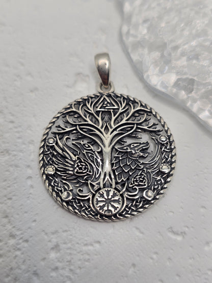 Honor ancient lore and powerful symbols with the Viking Raven Wolf Yggdrasil Pendant, crafted in solid 925 sterling silver. Centered on Yggdrasil—the Norse Tree of Life—this design unites the raven (wisdom, knowledge) and the wolf (strength, guardianship) around interlacing motifs, celebrating connection, courage, and timeless heritage.

Wear it as a daily talisman or gift it to a lover of Norse mythology—crisp engraving and a polished finish give this piece a striking, meaningful presence.

Key Features:

