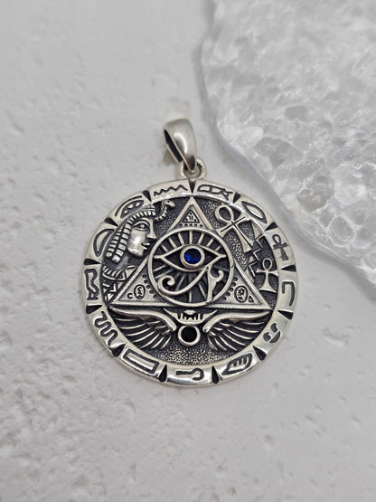 Unlock ancient insight and royal symbolism with this Egyptian Pyramid &amp; All-Seeing Eye Pendant, crafted in solid 925 sterling silver and set with a captivating lapis lazuli at the centre. The eye within a triangle evokes enlightenment and protection, while surrounding motifs—pyramid, wings of Horus, and hieroglyphic accents—create a richly detailed medallion that blends history, mystery, and style.

Wear it as a conversation-starting talisman or gift it to a lover of ancient cultures and esoteric design