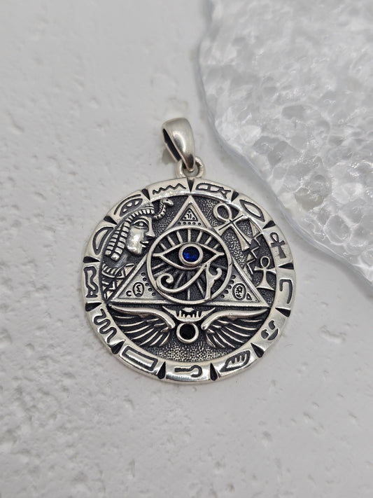 Unlock ancient insight and royal symbolism with this Egyptian Pyramid &amp; All-Seeing Eye Pendant, crafted in solid 925 sterling silver and set with a captivating lapis lazuli at the centre. The eye within a triangle evokes enlightenment and protection, while surrounding motifs—pyramid, wings of Horus, and hieroglyphic accents—create a richly detailed medallion that blends history, mystery, and style.

Wear it as a conversation-starting talisman or gift it to a lover of ancient cultures and esoteric design