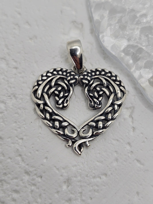 Celtic Horse Heart Knot in 925 Sterling Silver
Celebrate love, loyalty, and heritage with this Celtic Horse Heart Knot pendant, crafted in 925 sterling silver. A heart-shaped design intertwines with Celtic knotwork, culminating in twin horse heads—a graceful tribute to companionship and the free spirit of the horse.

Design & Symbolism

    Heart Knot: Symbol of love, unity, and enduring affection.

    Twin Horse Heads: Represents companionship, loyalty, and a free spirit.

    Celtic Knotwork: Endless loo