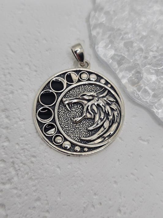 Tap into the power of myth and moonlight with this Moon Phase Dragon Pendant, handcrafted from 925 sterling silver and inlaid with natural black onyx. This piece is more than just a pendant—it's a protective amulet that connects strength, spirituality, and symbolism in one meaningful design.

A fierce dragon coils around the lunar phases, capturing the energy of transformation, balance, and the cycle of life. The black onyx adds a protective, grounding energy, making this pendant ideal for anyone navigating