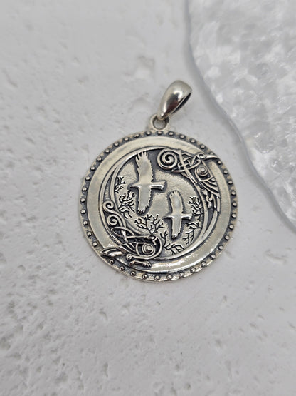 Step into the mystic shadows of the ancient forest with this Viking Crow Medallion, forged from solid 925 sterling silver and brought to life with deep symbolism and fine detail. At the heart of the design stand Huginn and Muninn, Odin’s trusted ravens, surrounded by an enchanted woodland scene carved into silver—a tribute to Norse mythology and the pursuit of knowledge.

Encircling the forest and birds is a ring of Norse runes, each symbol a whisper of ancient magic, representing insight, wisdom, and the u
