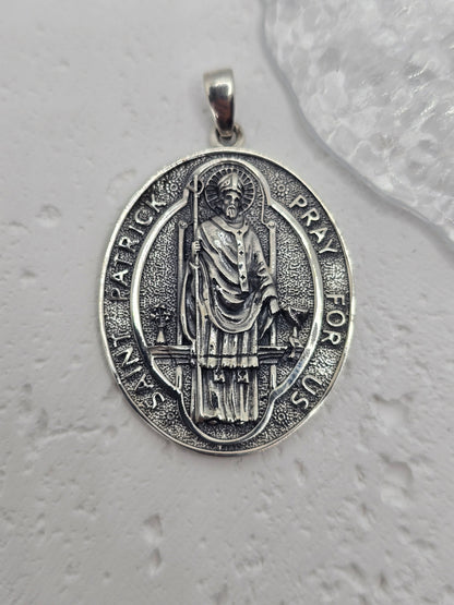 Saint Patrick Protection in Precious Metal
A meaningful symbol of guidance and faith, this Saint Patrick amulet pendant is crafted in 925 sterling silver with crisp relief detailing. Depicting Saint Patrick — revered for bringing Christianity to Ireland — it’s a powerful devotional piece and a refined everyday pendant.

Design & Symbolism

    Saint Patrick Figure: Traditionally shown holding a cross, symbolising protection, courage, and steadfast faith.

    Protective Emblem: Worn as a token of spiritual 
