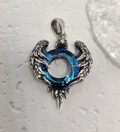 Channel strength, freedom, and clarity with the Eagle Wings Amulet, crafted in luminous 925 sterling silver and set with a deep blue Austrian crystal. Finely sculpted wings frame the radiant centre stone, creating a bold talisman that elevates everyday style and meaningful gifting.

Key Features:

Made from solid 925 Sterling Silver
Eagle wing motif symbolising power, freedom, and vision
Blue Austrian crystal centre for vibrant sparkle and depth
Polished detailing with light-catching feather texture
Ideal s
