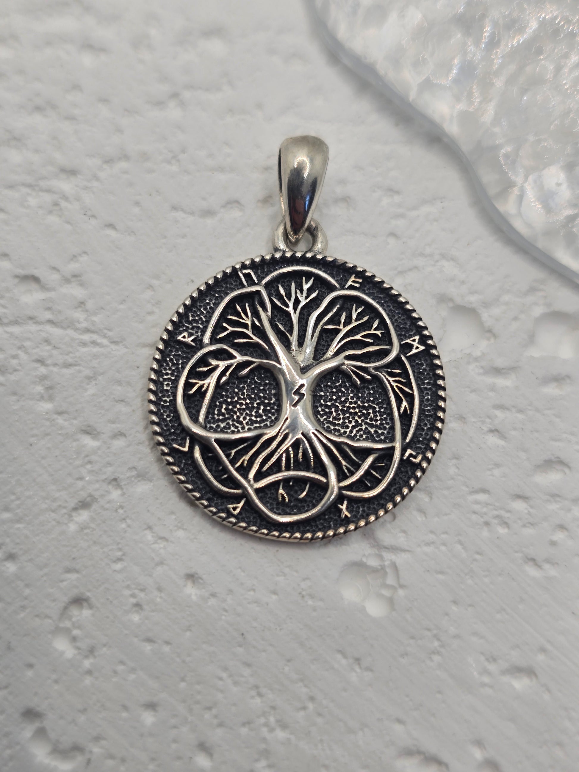 Celebrate growth, strength, and ancient wisdom with the Tree of Life Pendant, crafted in solid 925 sterling silver and encircled by Norse runes. Interlacing roots and branches form a circular motif that reflects the eternal cycle of life, connection, and renewal—making this a meaningful talisman for nature lovers and mythology enthusiasts alike.

Key Features:

Made from solid 925 Sterling Silver
Tree of Life design surrounded by ancient runes for symbolic depth
Represents growth, strength, protection, and 