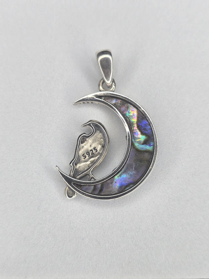 Back view of sterling silver raven moon amulet with abalone shell crescent