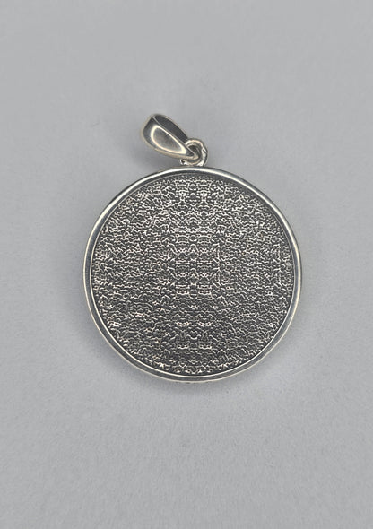Back view of sterling silver dragon pendant with textured circular finish