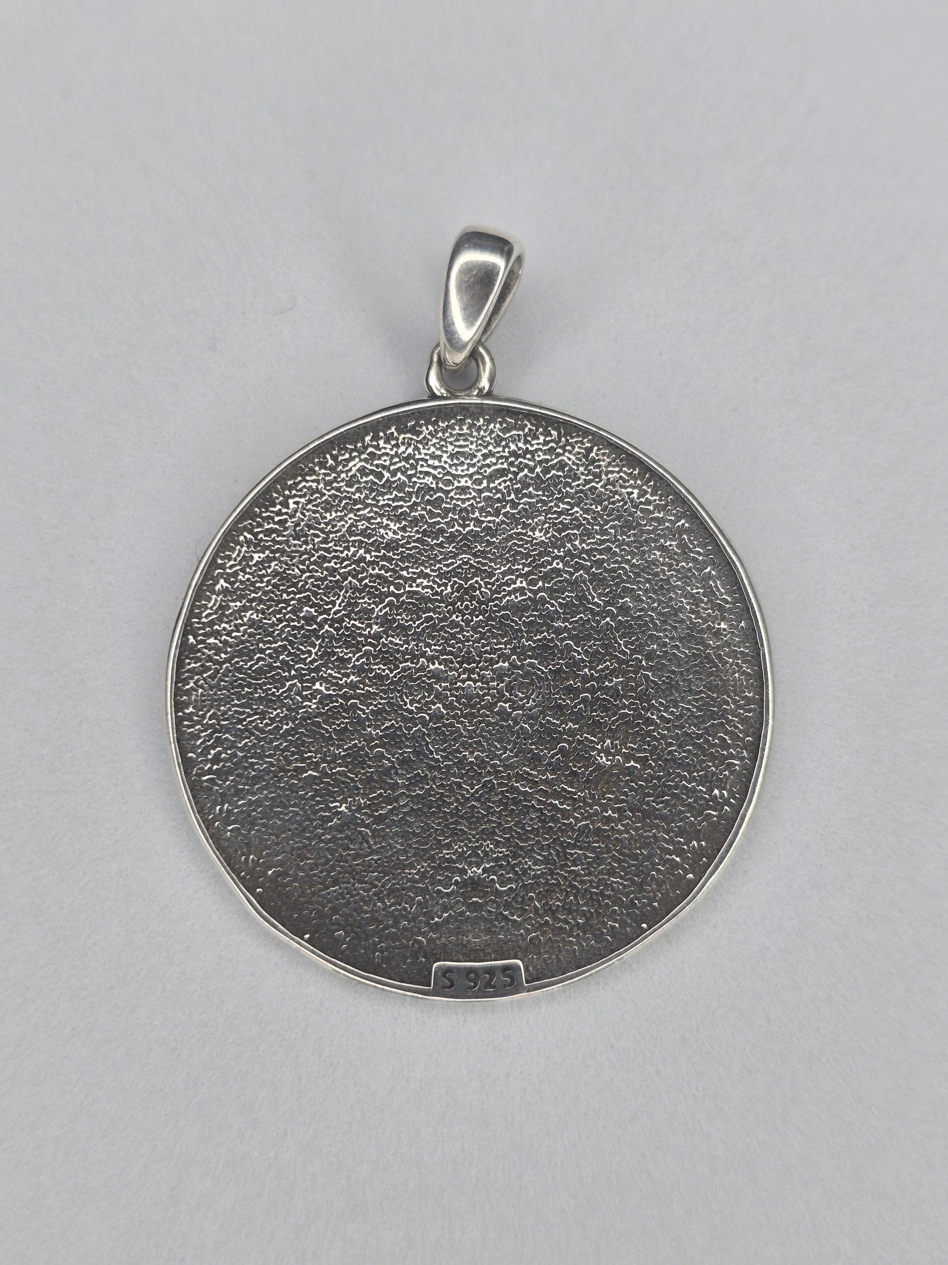 Back view of Seven Archangels sterling silver pendant with textured finish and 925 hallmark