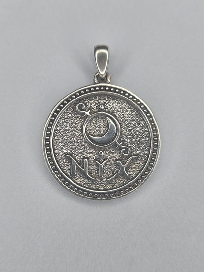 Back view of Nyx pendant with crescent moon symbol and NYX inscription in sterling silver