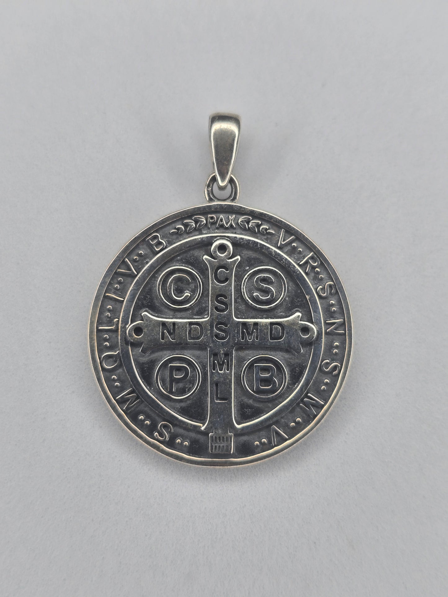 Back view of Saint Benedict cross pendant in sterling silver with engraved sacred symbols