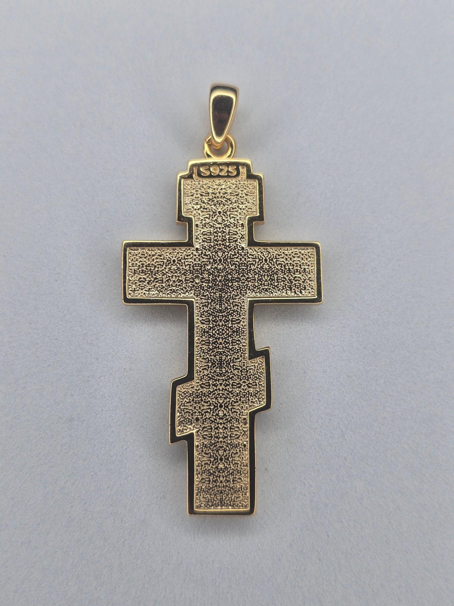 Back view of gold plated sterling silver crucifix pendant with textured finish and 925 hallmark
