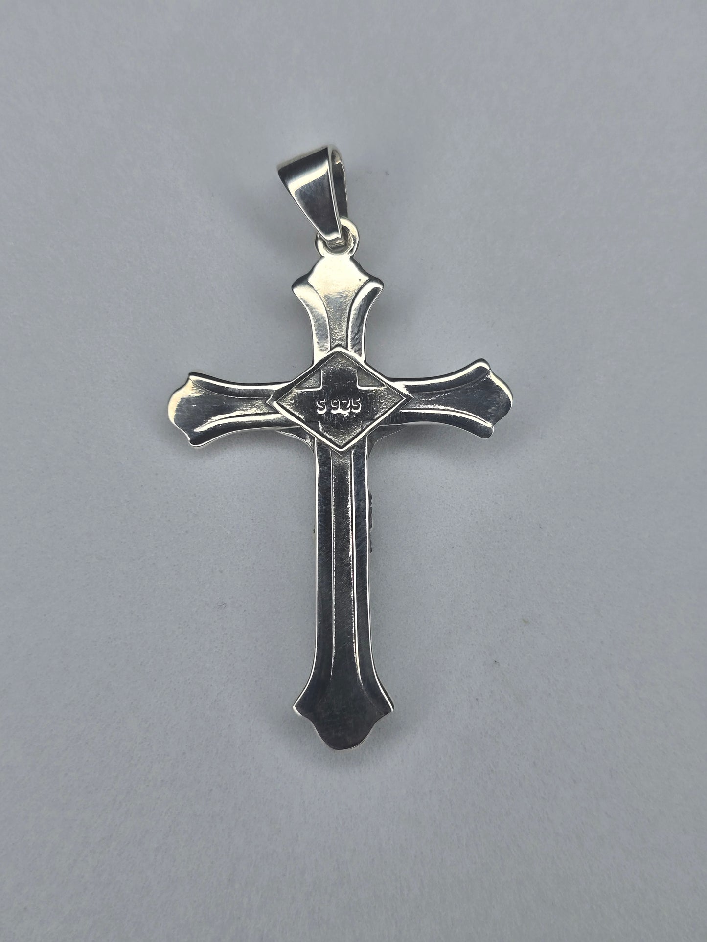 Back view of sterling silver crucifix pendant with smooth finish and S925 hallmark