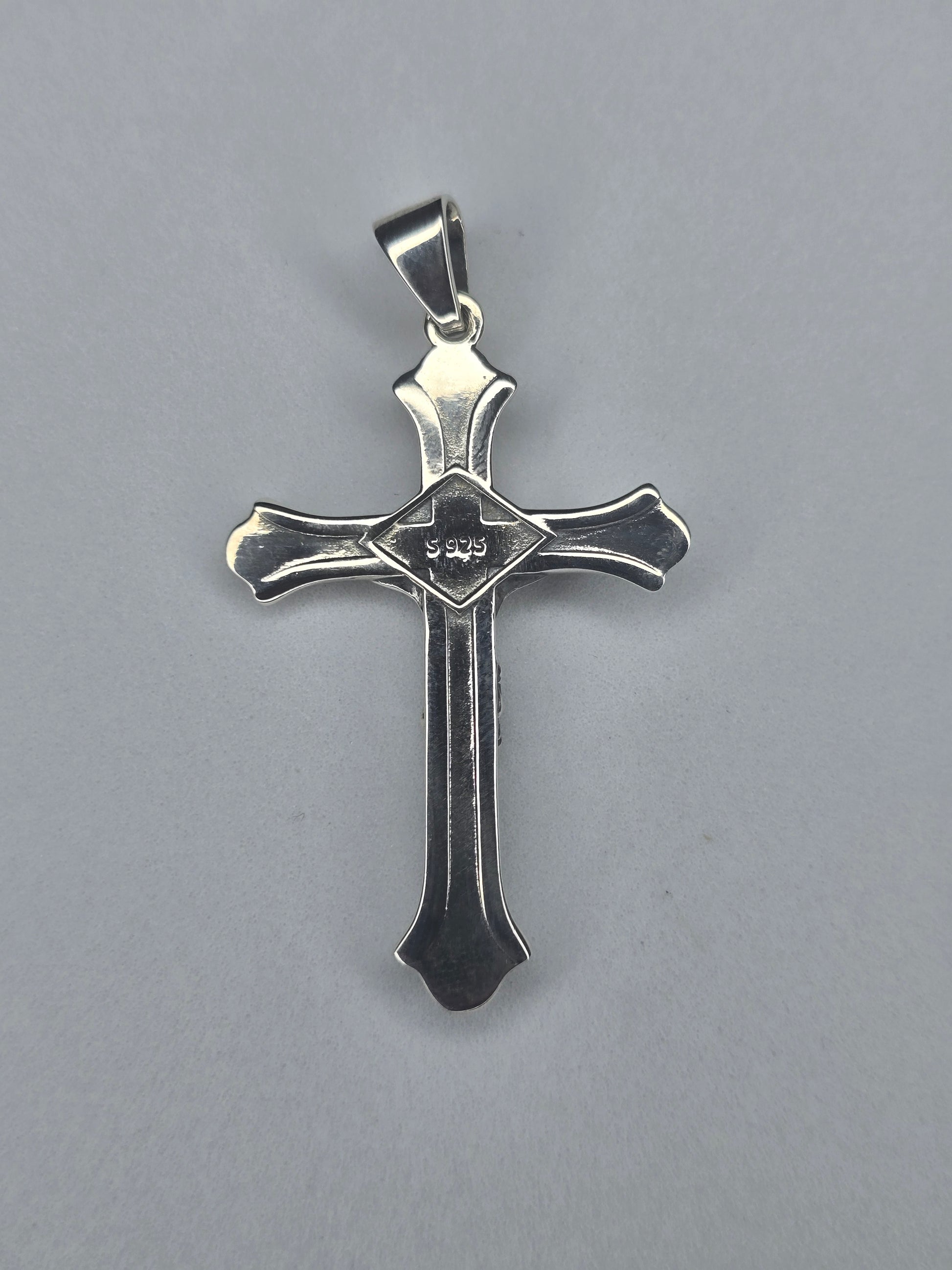 Back view of sterling silver crucifix pendant with smooth finish and S925 hallmark
