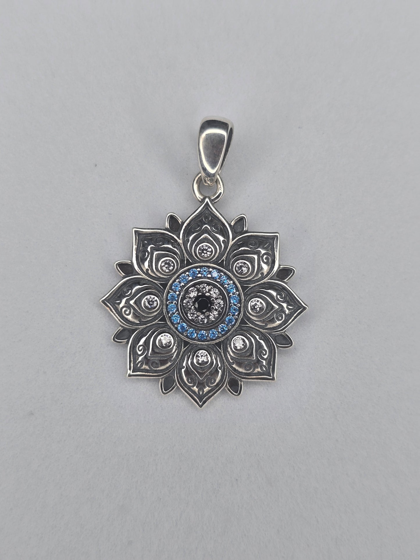 Lotus evil eye pendant in solid 925 sterling silver with blue stones and central protective eye