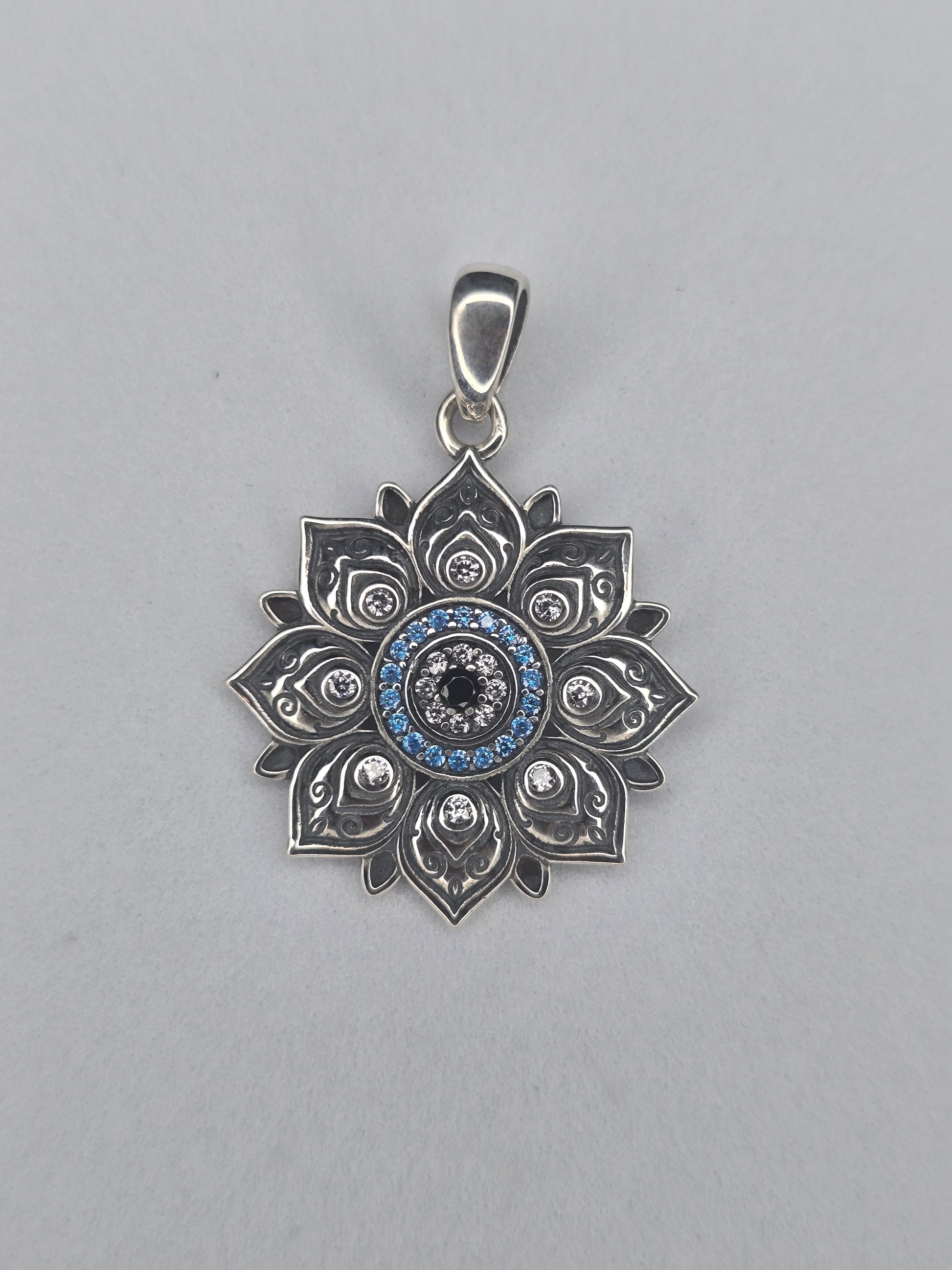 Lotus evil eye pendant in solid 925 sterling silver with blue stones and central protective eye