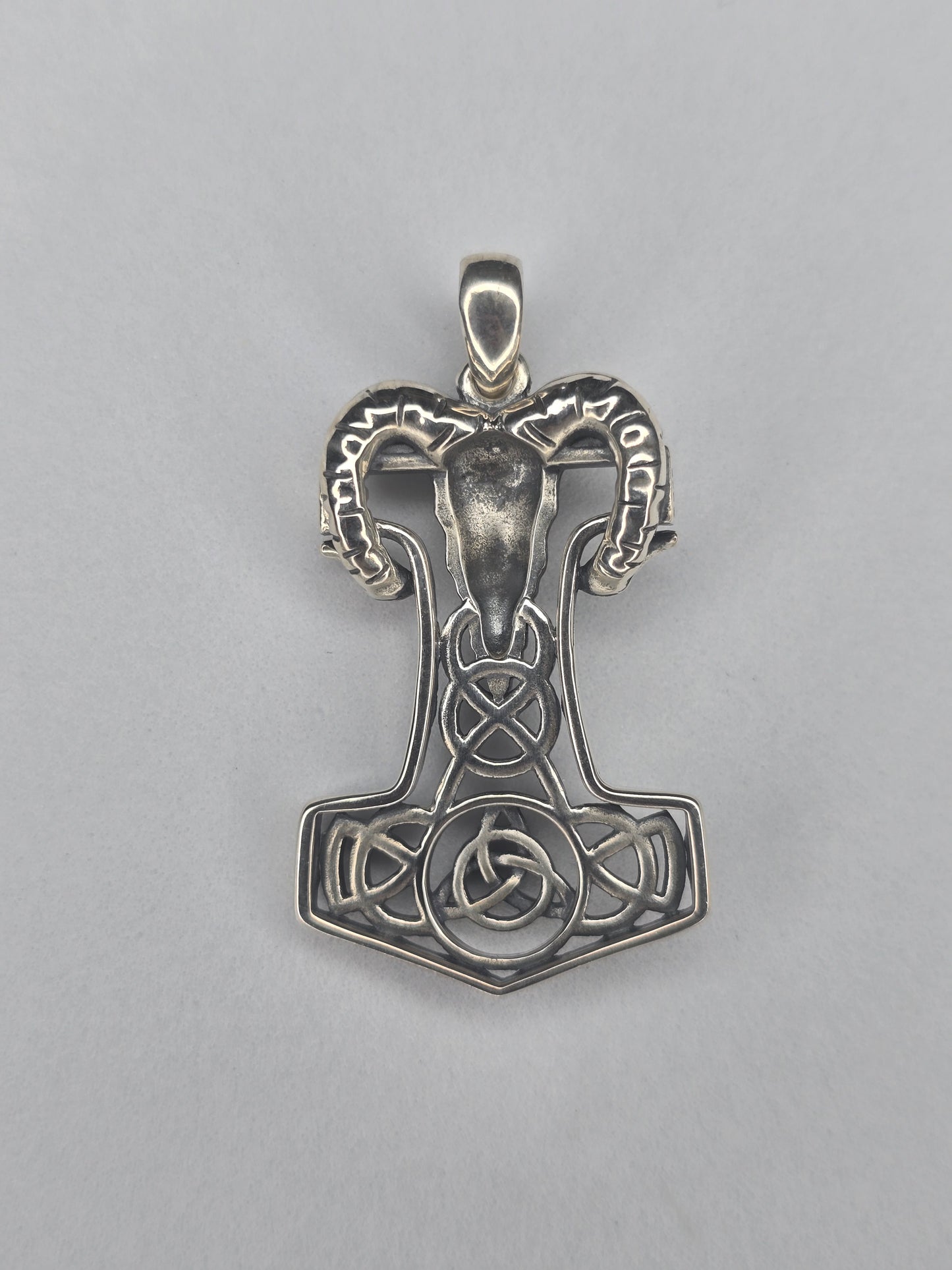 Back view of sterling silver Mjolnir pendant with openwork knot design and textured finish