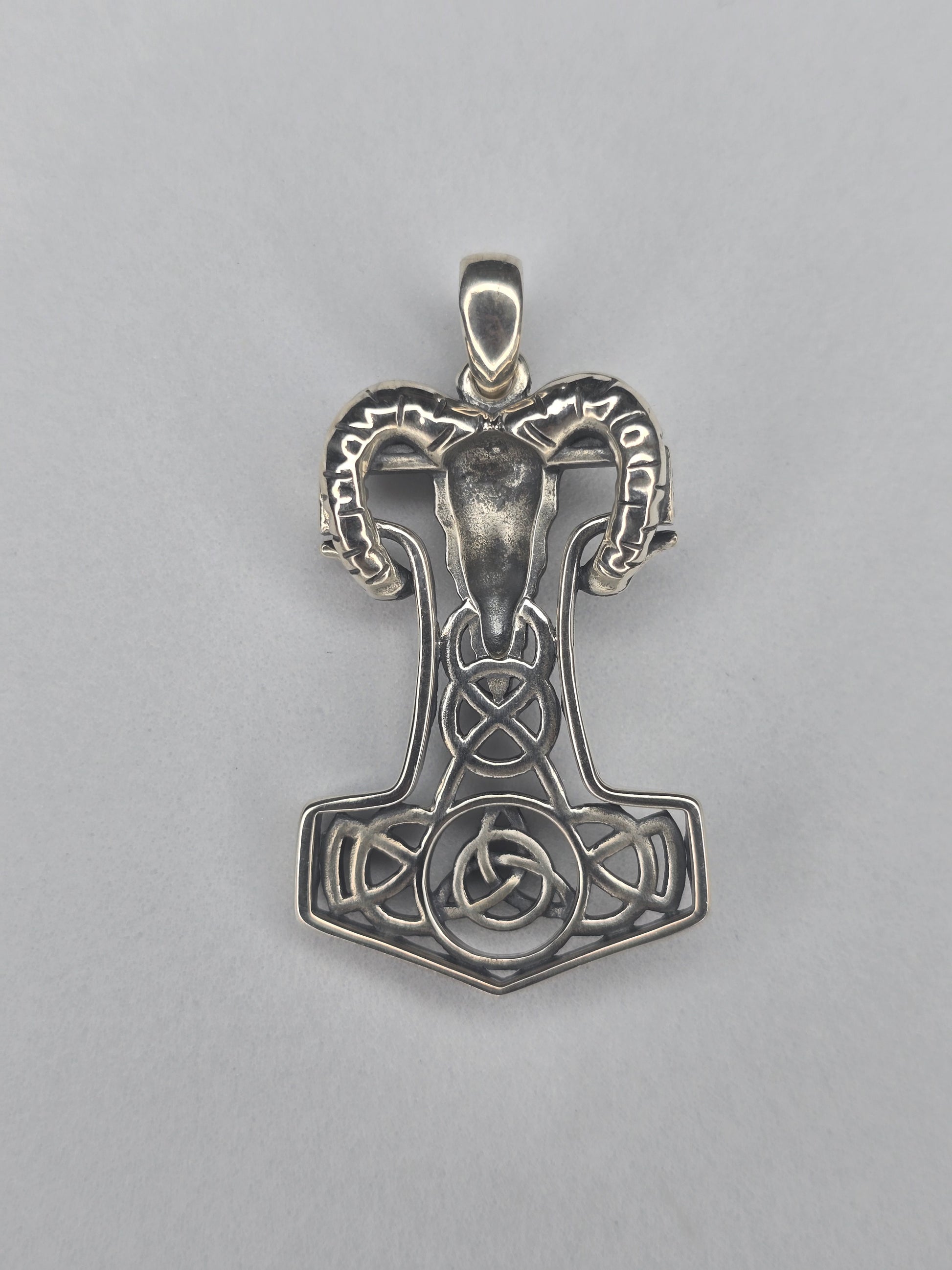 Back view of sterling silver Mjolnir pendant with openwork knot design and textured finish