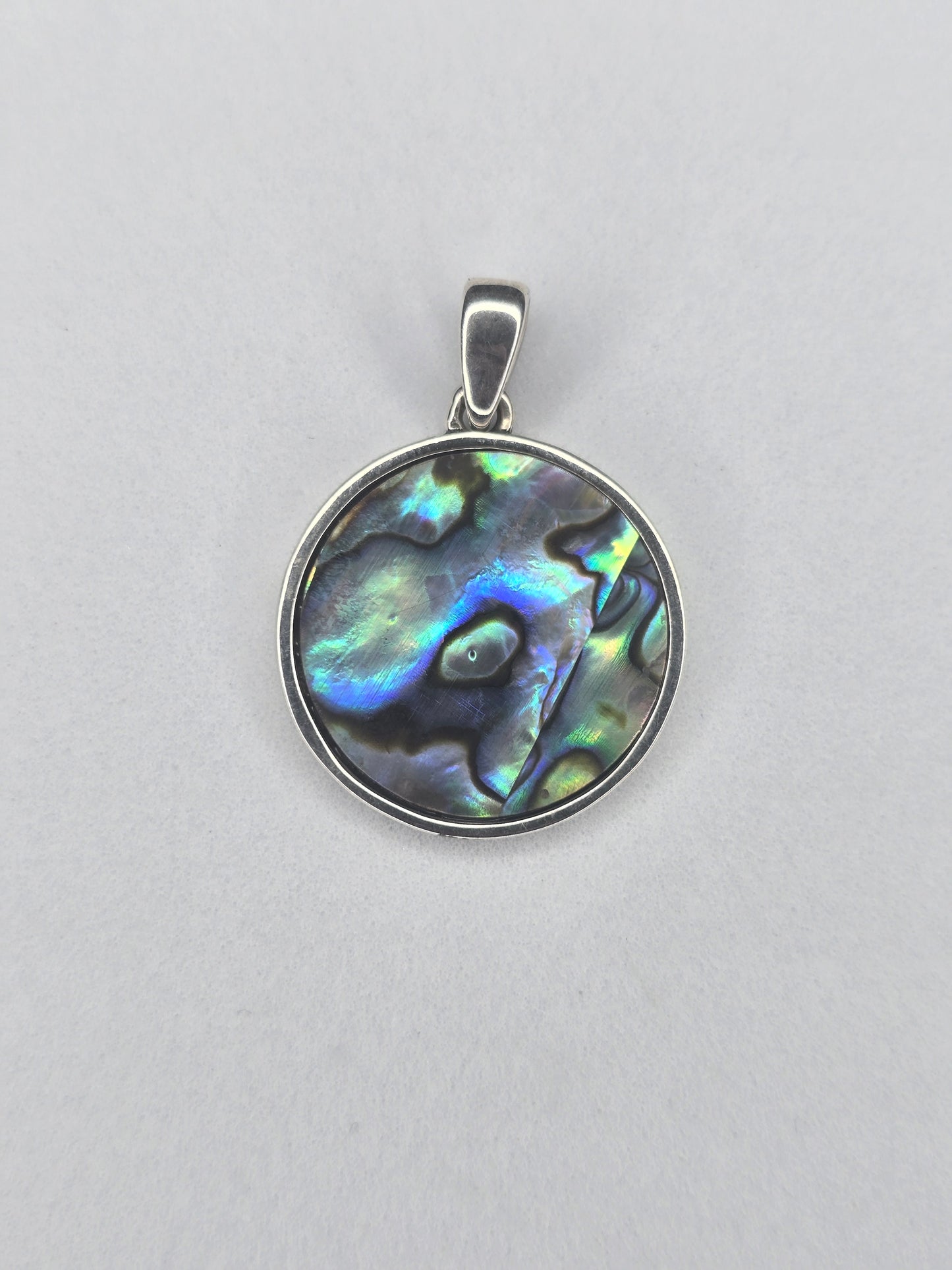 Back view of round abalone shell pendant set in 925 sterling silver