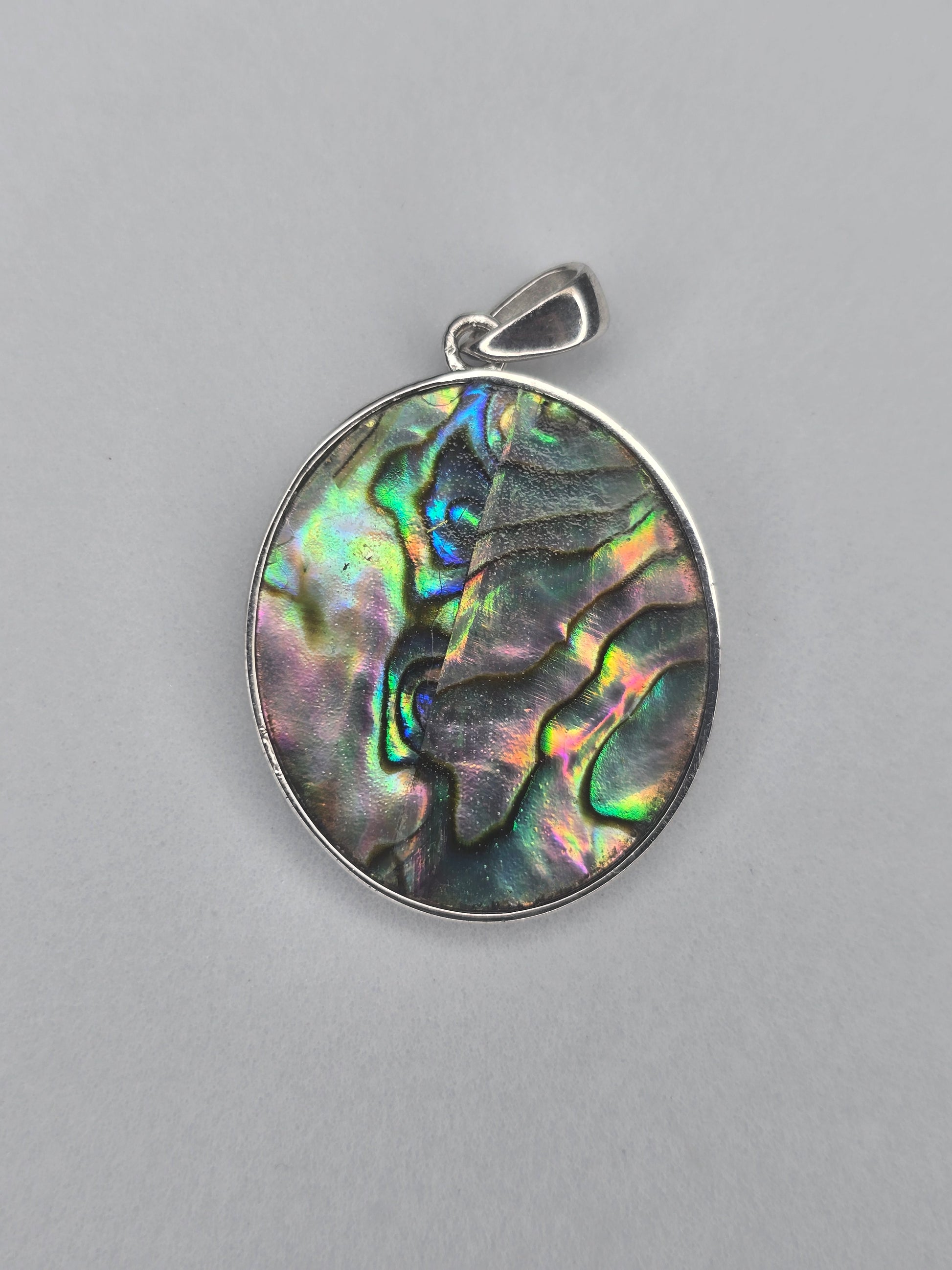 Back view of sterling silver Saint Michael pendant with natural abalone shell texture