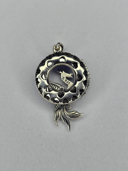 Back view of Phoenix Rising silver pendant with openwork circular frame and phoenix tail detail