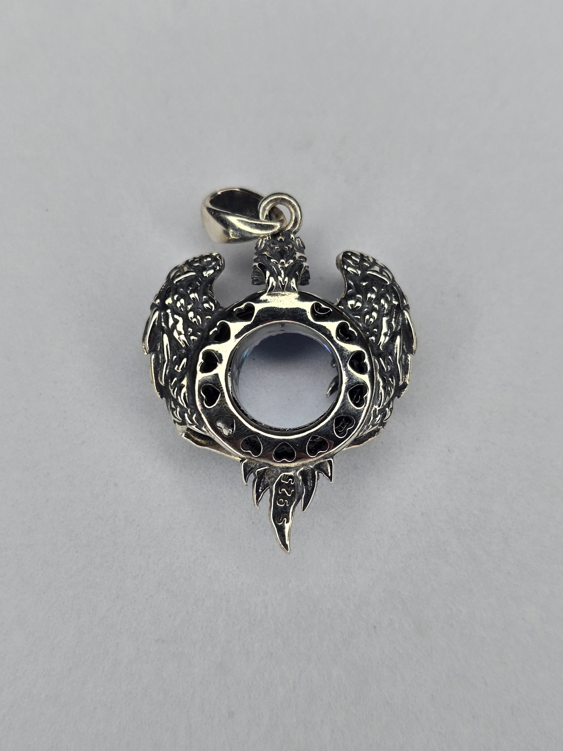 Back view of silver eagle wings pendant with open crystal setting
