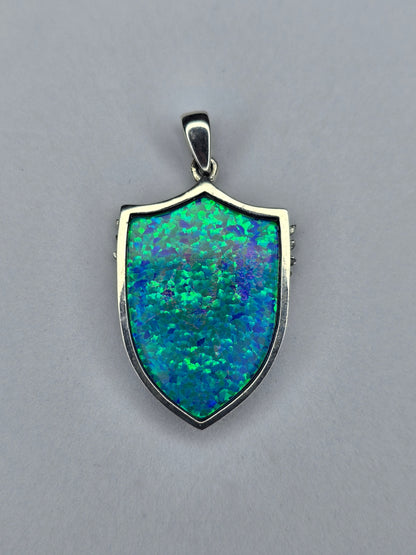 Back view of Saint Michael shield pendant in sterling silver with polished frame and opal inlay