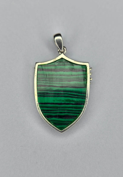Back view of sterling silver Archangel Michael shield pendant with polished frame and natural malachite stone