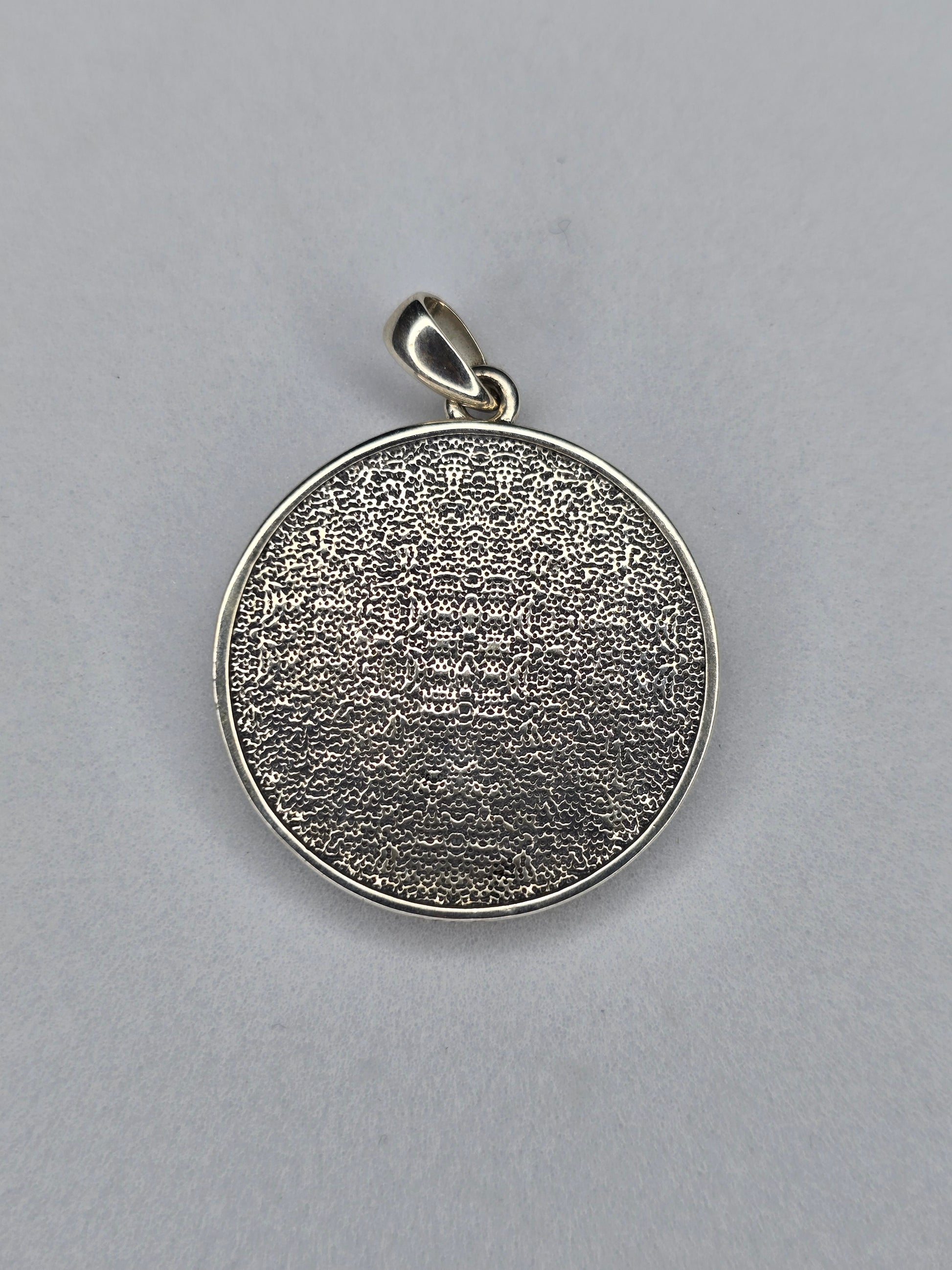 Back view of Anubis amulet with textured sterling silver surface
