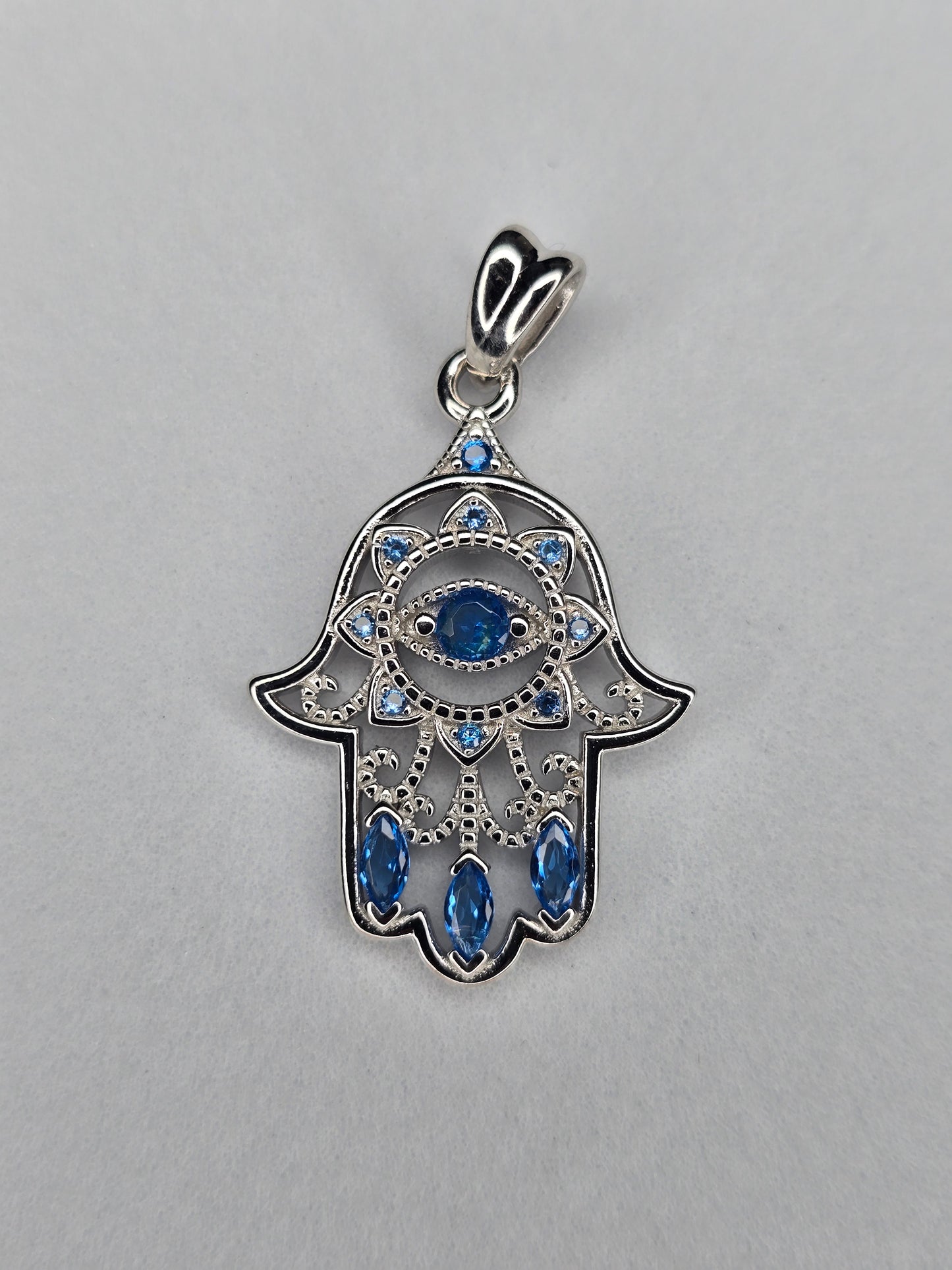 Hamsa hand pendant in 925 sterling silver with blue crystals front view