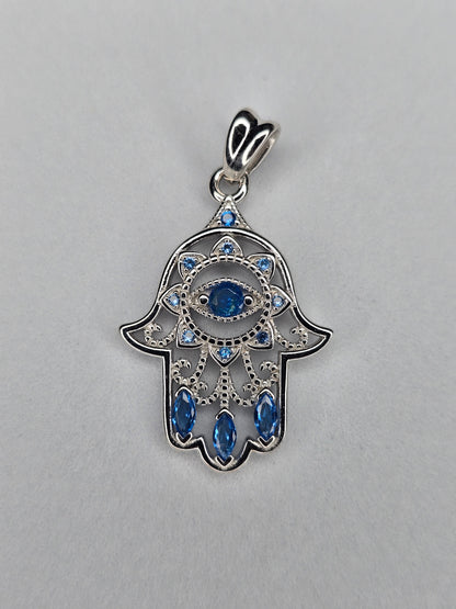 Hamsa hand pendant in 925 sterling silver with blue crystals front view