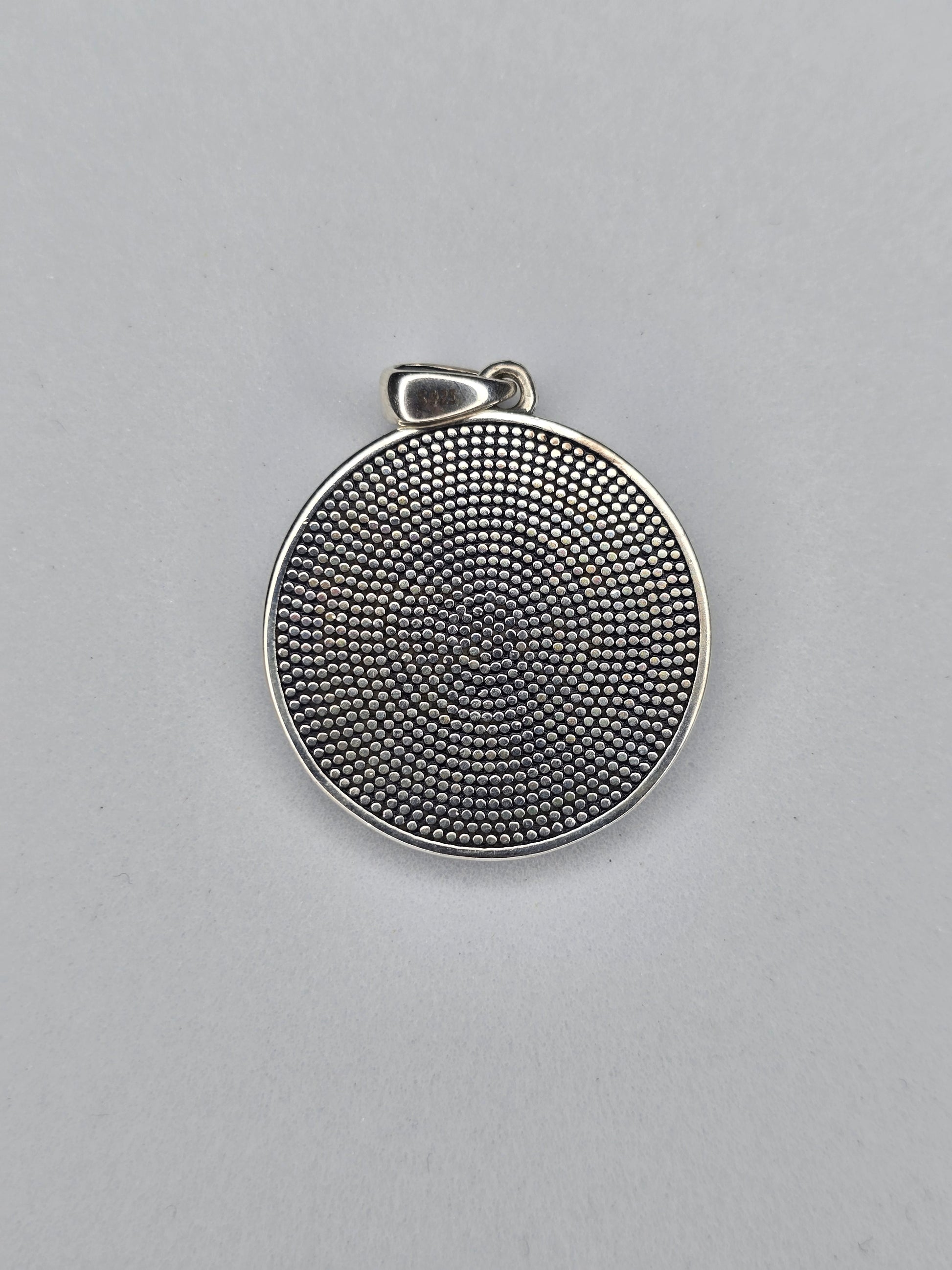 Back view of sterling silver pentagram amulet with textured finish and hallmark