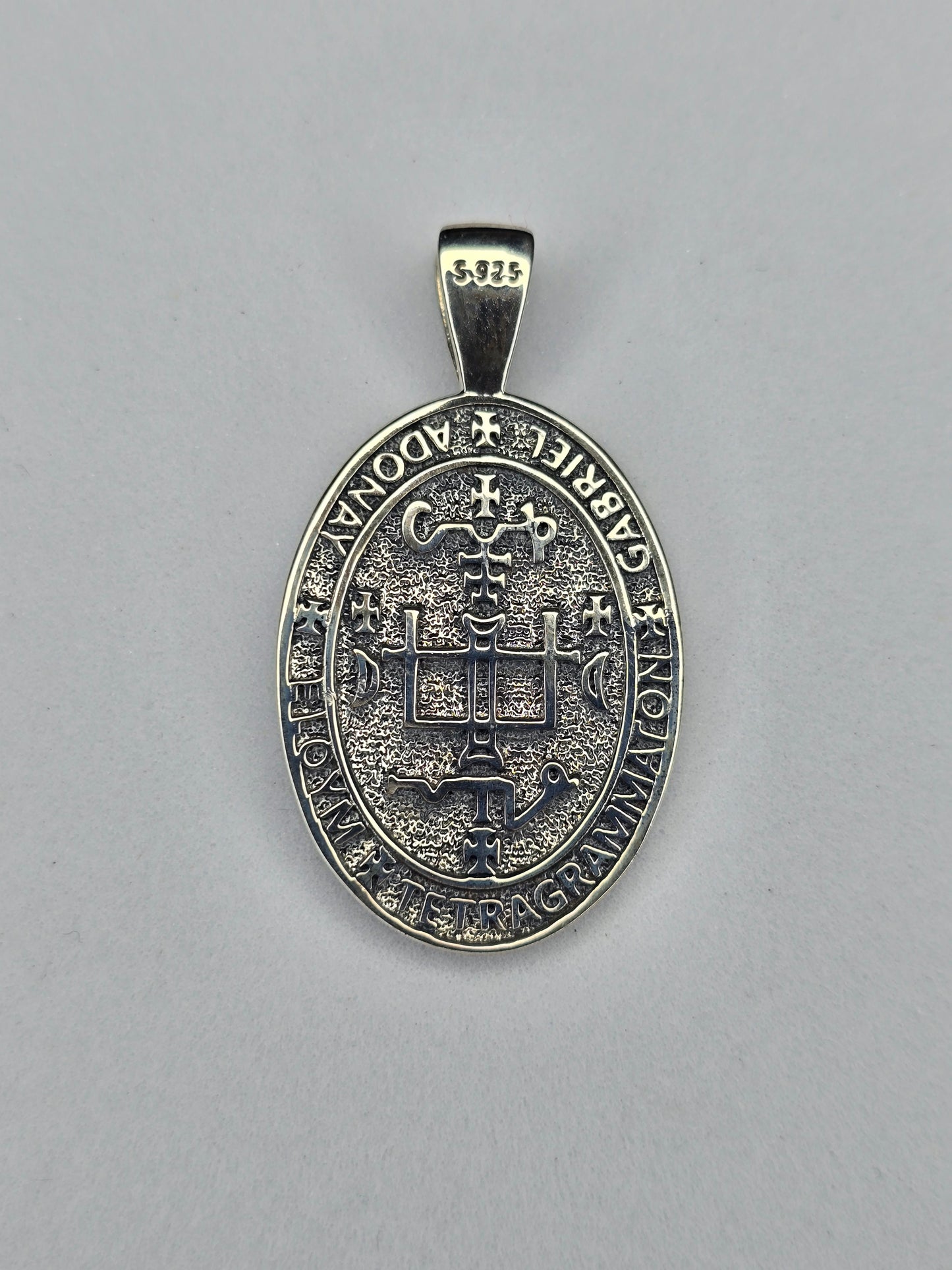 Back view of Saint Gabriel religious medal with cross and symbolic inscription in sterling silver