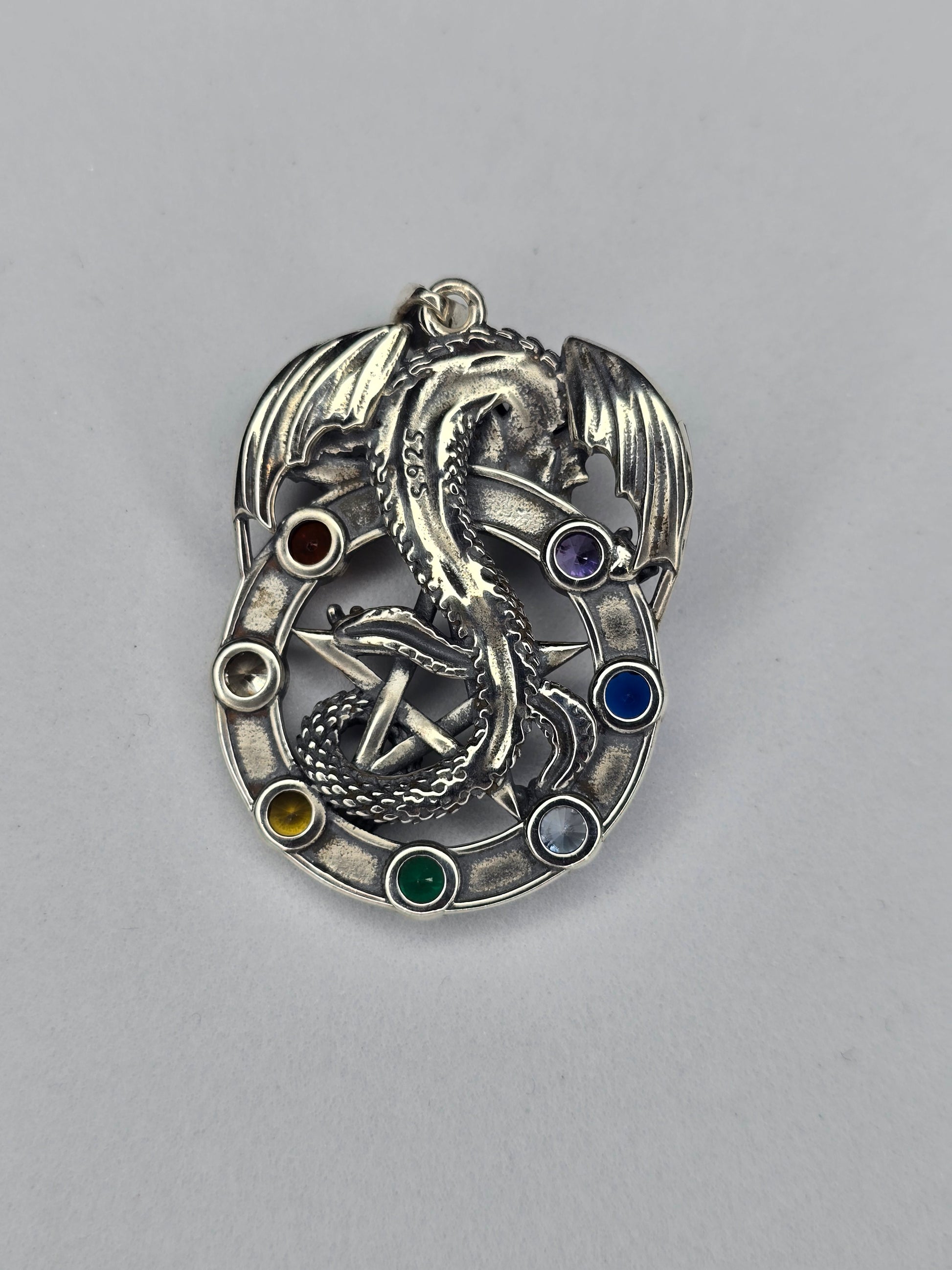 Back view of sterling silver dragon pentagram pendant showing detailed relief and hallmark
