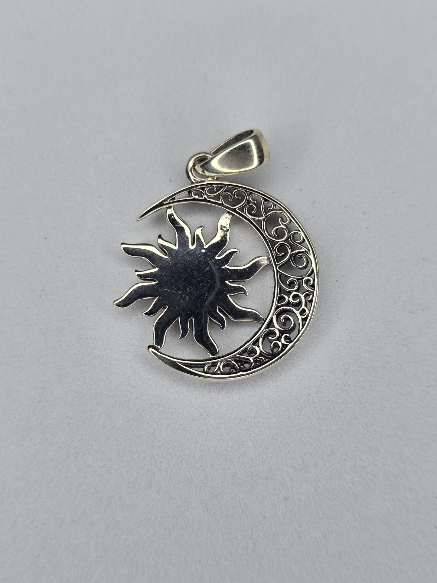 Rear view of sterling silver sun moon pendant with smooth textured back